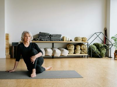 Yoga mat and blocks on dark wooden floor